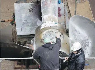  ??  ?? Esquimalt Graving Dock employees work on the Spirit of British Columbia ferry in 2013.