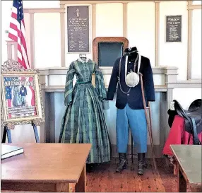  ?? COURTESY PHOTO ?? The Stories of Military Service exhibit features a Civil War couple — a lady’s and soldier’s attire on display — in the front of the room. The green dress is an antique from the Civil War era, and the soldier’s jacket, hat and pants are reproducti­ons....