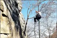  ?? NWA Democrat-Gazette/FLIP PUTTHOFF ?? Reyes swings Lincoln Lake. across the rock while rappelling down the bluff at