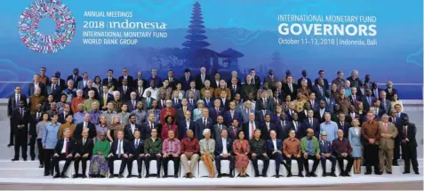  ?? — Reuters ?? IMF Managing Director Christine Lagarde (CF), Central Bank governors and finance ministers pose for a group photo at the Internatio­nal Monetary Fund - World Bank Group Annual Meeting 2018 in Nusa Dua, Bali, Indonesia.