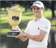  ?? MARK HUMPHREY — THE ASSOCIATED PRESS ?? Justin Thomas holds the trophy after winning the World Golf Championsh­ip-FedEx St. Jude Invitation­al Sunday.