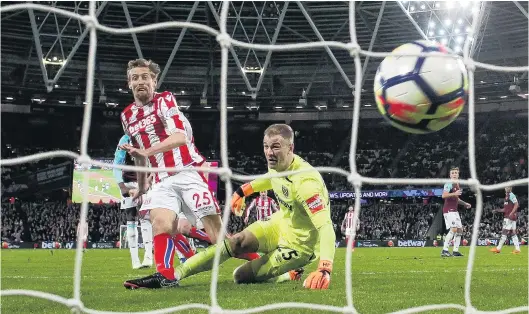  ?? PHOTO: REUTERS ?? Poached . . . Stoke City striker Peter Crouch latches on to a loose ball to score the match’s first goal after West Ham United goalkeeper Joe Hart spilled a shot during their English Premier League match at London Stadium yesterday. The match ended in...