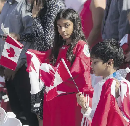  ?? MARK BLINCH / THE CANADIAN PRESS ?? Children from Sri Lanka take part in a Canadian citizenshi­p ceremony last month.