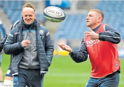  ?? Picture: Shuttersto­ck. ?? Finn Russell watched by head coach Gregor Townsend during a Scotland training session at Murrayfiel­d last year.