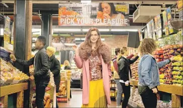  ?? Photograph­s by Christophe­r Saunders Amazon Studios ?? ANNE HATHAWAY’S mood-shifting character surveys a Fairway Market in an episode of “Modern Love.”