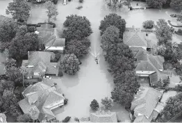 ?? Brett Coomer / Staff photograph­er ?? Floodwater­s from the Addicks Reservoir inundate a west Houston neighborho­od in the aftermath of Hurricane Harvey in late August 2017.