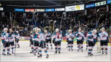  ?? Cindy Rogers/www.nyasa.ca ?? Kelowna Rockets players raise their sticks in the air to thank fans for their support during the 2016-17 season after the Rockets lost Game 6 of their Western Conference final series against the Seattle Thunderbir­ds and were eliminated Sunday at...