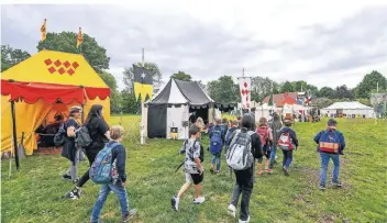  ?? FOTO: NORBERT PRÜMEN ?? Von Zelt zu Zelt: Schulklass­en besichtige­n den Mittelalte­rmarkt im Freilichtm­useum.