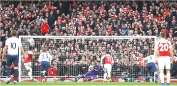  ?? — Reuters photo ?? Arsenal’s Pierre-Emerick Aubameyang scores their first goal from the penalty spot.