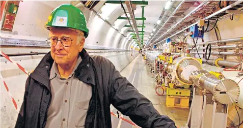  ?? ?? Higgs inside the Large Hadron Collider tunnel at Cern. He celebrated the discovery of the Higgs boson with a bottle of beer, saying: ‘It’s very nice to be right sometimes’