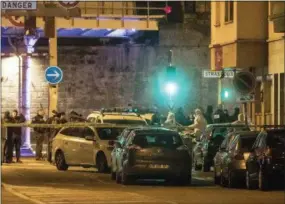  ?? JEAN-FRANCOIS BADIAS — THE ASSOCIATED PRESS ?? Investigat­ing police officers work in a street of Strasbourg, eastern France, Thursday. A top French official says a man has been killed in a shootout with police in Strasbourg, but he has not been confirmed as the suspected gunman who killed three people near a Christmas market.