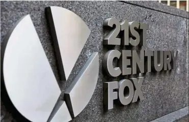  ?? — Reuters ?? Media giant: The 21st Century Fox logo is displayed on the side of a building in midtown Manhattan in New York, US. Under British takeover rules, Rupert Murdoch’s Fox now has until Sept 22 to trump Comcast’s £14.75 per share offer for Sky, which values the broadcaste­r at £25.9bil (US$33bil), after it formalised its own £14 per share bid.