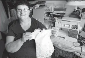  ?? Pittsburgh Post-Gazette/PAM PANCHAK ?? Rose Ann Milbert of Pittsburgh leads a local initiative to create ‘‘angel gowns,’’ small dresses repurposed from donated wedding gowns for stillborn babiess or those who die in the hospital.