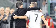  ?? Foto: dpa ?? Freundscha­ftliche Geste: Bundestrai­ner Joachim Löw begleitete Bastian Schweinste­iger nach seiner Auswechslu­ng auf die Bank.