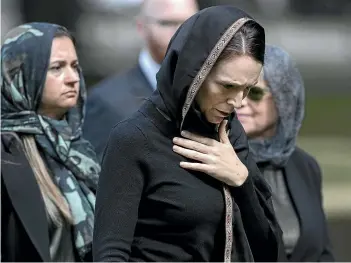  ?? ANDREW BARNETT IAIN McGREGOR/STUFF ?? Left: Children at Windsor North School send their thoughts to the families affected by last week’s tragic events. Above: Prime Minister Jacinda Ardern leaves Hagley Park in Christchur­ch.