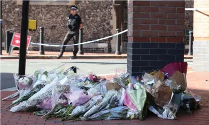  ??  ?? Flowers placed in Reading town centre, the scene of a multiple stabbing attack which took place on Saturday, leaving three people dead and another three seriously injured. Photograph: Jonathan Brady/PA