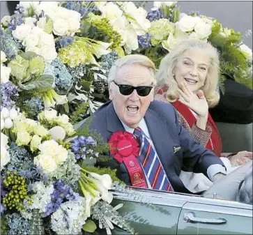  ?? Reed Saxon Associated Press ?? LEGENDARY Dodgers broadcaste­r Vin Scully rides with his wife, Sandi, in the 2014 Rose Parade. Scully served as grand marshal. “She was the wind beneath my wings,” he says of Sandi, who died Jan. 3.