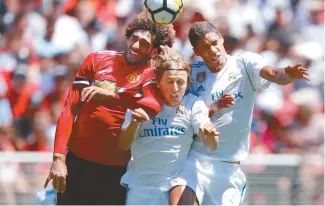  ?? EPA-Yonhap ?? Manchester United midfielder Marouane Fellaini, left, Real Madrid midfielder Luka Modric, center, and Real Madrid defender Raphael Varane are in action during the first half of the Internatio­nal Champions Cup match at Levi's Stadium in Santa Clara,...