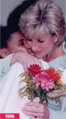  ??  ?? Poignant: Diana hugs a girl in a Chicago hospital 1996