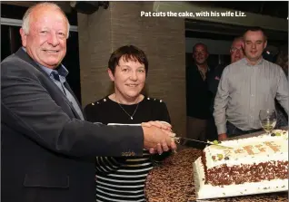  ??  ?? Pat cuts the cake, with his wife Liz.