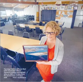  ?? PHOTO / GEORGE NOVAK ?? Tauranga Yacht and Power Boat Club commodore Delwyn Keyworth holding a photograph taken in 1984 of the site where the second clubrooms were built.