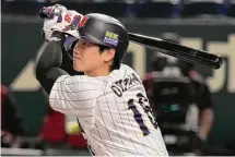  ?? Eugene Hoshiko/Associated Press ?? Shohei Ohtani of Japan hits a double in the fourth inning of the Pool B game against China at the World Baseball Classic in Tokyo on Thursday. Ohtani is Japan’s biggest baseball export with his popularity surpassing that of national heroes Ichiro Suzuki and Hideo Nomo.