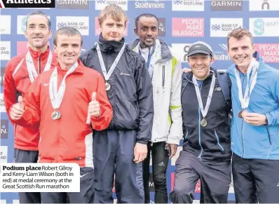  ??  ?? Podium place Robert Gilroy and Kerry-Liam Wilson (both in red) at medal ceremony at the Great Scottish Run marathon