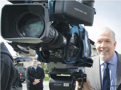  ?? MARK VAN MANEN ?? B.C. NDP Leader John Horgan smiles while looking over a camera before speaking in Surrey on Monday. The Opposition leader says his party would provide $500,000 a year for Wraparound, a community program that benefits at-risk kids. The provincial...