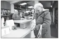  ?? NWA Democrat-Gazette/DAVID GOTTSCHALK ?? Theola Greene (right) of Prairie Grove smiles Thursday after being assisted by Iva Sorrell, library director, at the Prairie Grove Public Library. The city is purchasing the former Walmart Express building and plans to move the library and children’s...