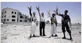  ??  ?? Rebels wave their weapons Tuesday at the residence of one of their commanders in Sanaa, Yemen, which was destroyed by a Saudi-led airstrike. Saudi Arabia’s increasing role in Yemen, Iraq and Syria has made it the target of groups like the Islamic...
