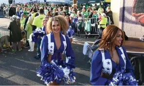  ?? The Sentinel-Record/Lance Brownfield ?? ■ The Dallas Cowboys Cheerleade­rs leave the Bridge Street area after performing Friday at the start of the First Ever 20th Annual World’s Shortest St. Patrick’s Day Parade.