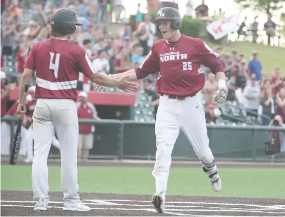  ?? ALLEN CUNNINGHAM/ FOR THE SUN- TIMES ?? Plainfield North’s Brady Miller ( 25) is greeted by teammate Cameron Kissel after hitting a home run in the Class 4A championsh­ip game Saturday.