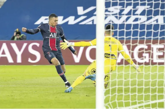  ?? (Photo: AFP) ?? Paris Saint-germain’s French forward Kylian Mbappe (left) kicks the ball past Brest’s French goalkeeper Gautier Larsonneur during the French L1 match at Parc des Princes stadium in Paris, yesterday.