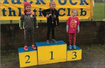  ??  ?? Kellie Sheridan (centre), winner of the Under-7 race at the Blackrock AC event.