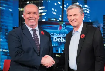  ?? CP PHOTO ?? Premier John Horgan and Liberal leader Andrew Wilkinson following the Electoral Reform Debate at Global Television in Burnaby on Thursday.