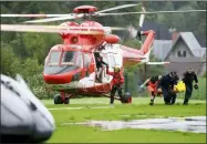  ?? BARTLOMIEJ JURECKI — THE ASSOCIATED PRESS ?? Top photos: Rescue helicopter brought to the hospital the first people injured by a lighting that struck in Poland’s southern Tatra Mountains during a sudden thundersto­rm Thursday in Zakopane, Poland.