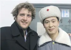  ??  ?? Scott Howe poses with one of the security guards at the Pyongyang Ice Arena. This was Howe’s fourth trip to North Korea.