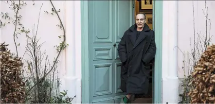  ?? High & Low: John Galliano. ?? Galliano in the doorway of his home in a scene from the documentar­y film, He is now back to being a celebrated designer. — Mubi via ap