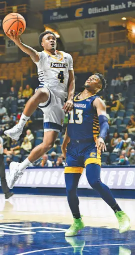  ?? PHOTO BY ANGELA FOSTER ?? The Gold team’s Tada Stricklen (4) shoots over the Blue team’s Malachi Smith during the UTC men’s basketball team’s Blue & Gold intrasquad scrimmage Thursday night at McKenzie Arena. The Mocs will host an exhibition against Wooster on Nov. 4.