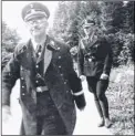  ??  ?? Hitler being saluted; right, one of the architects of the Holocaust, SS chief Heinrich Himmler, grins to the camera