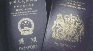  ??  ?? 0 ‘Chinese’ and ‘British’ Hong Kong passports at the centre of the row