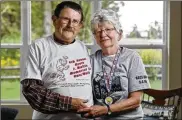  ?? ERIC ALBRECHT / DISPATCH ?? Phil and Cecelia Mullin wear T-shirts from 5K runs they organized in honor of their youngest son, Kevin, who died in 2001 of a brain tumor.