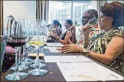  ?? AJC FILE ?? Guests sniff their first wine sample during a class at the Atlanta Food & Wine Festival in 2015.