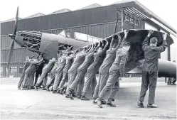  ??  ?? WAAF plotters at work at HQ Fighter Command, Bentley Priory, London; trainees manhandlin­g a Fairey Battle to a hangar at 2 School of Technical Training at Cosford, Shropshire, in March 1940; armourers preparing 112lb RL bombs in July 1918.