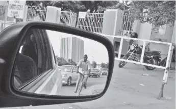  ?? — Thomson Reuters Foundation photos ?? A cyclist pedals amid traffic in Niamey, in Niger.