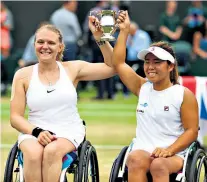  ??  ?? Champions: Jordanne Whiley and Yui Kamiji, her Japanese partner, celebrate after winning the women’s wheelchair doubles final at Wimbledon in 2017. It was their fourth successive title at the All England Club
