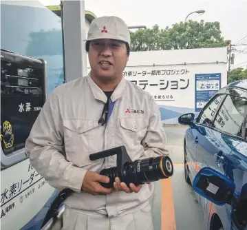  ?? (Julie Makinen/Los Angeles Times/TNS) ?? AN ATTENDANT prepares to fill up a Toyota Mirai at a Fukuoka sewage-treatment plant, which is creating hydrogen from biogas.