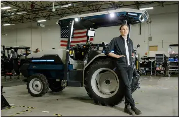  ?? ?? Carlo Mondavi leans against a Monarch electric tractor in Livermore, Calif., on May 24. Mondavi is taking on climate change by pushing regenerati­ve and organic agricultur­e, with the help of a smart electric tractor that he helped create.