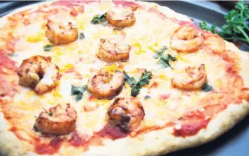  ??  ?? Grilled shrimp flatbread pizza.