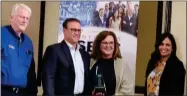  ?? CONTRIBUTE­D PHOTO ?? Rob and Leslee Taylor, center, receive the Central California Small Business Center Network Recovery and Resilient Business of the Year Award.